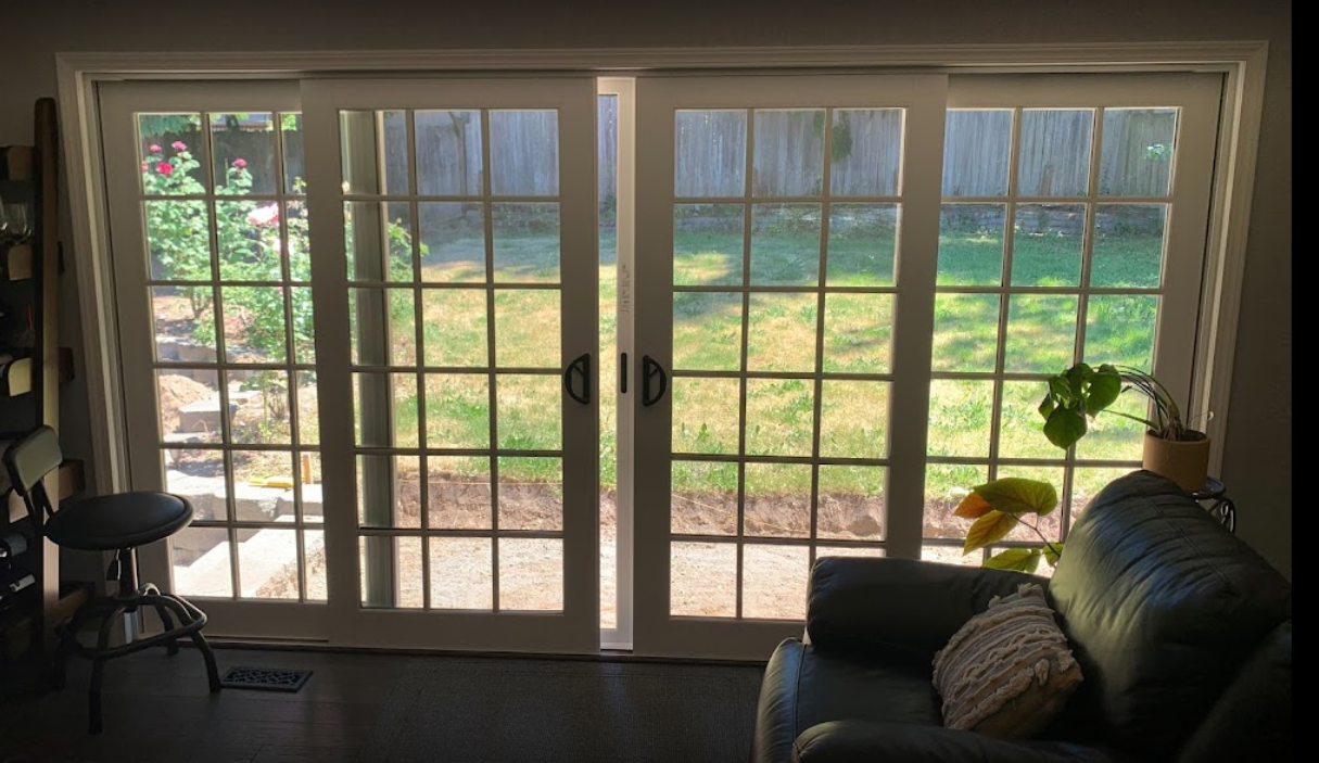 Backlit sliding glass door with garden view.