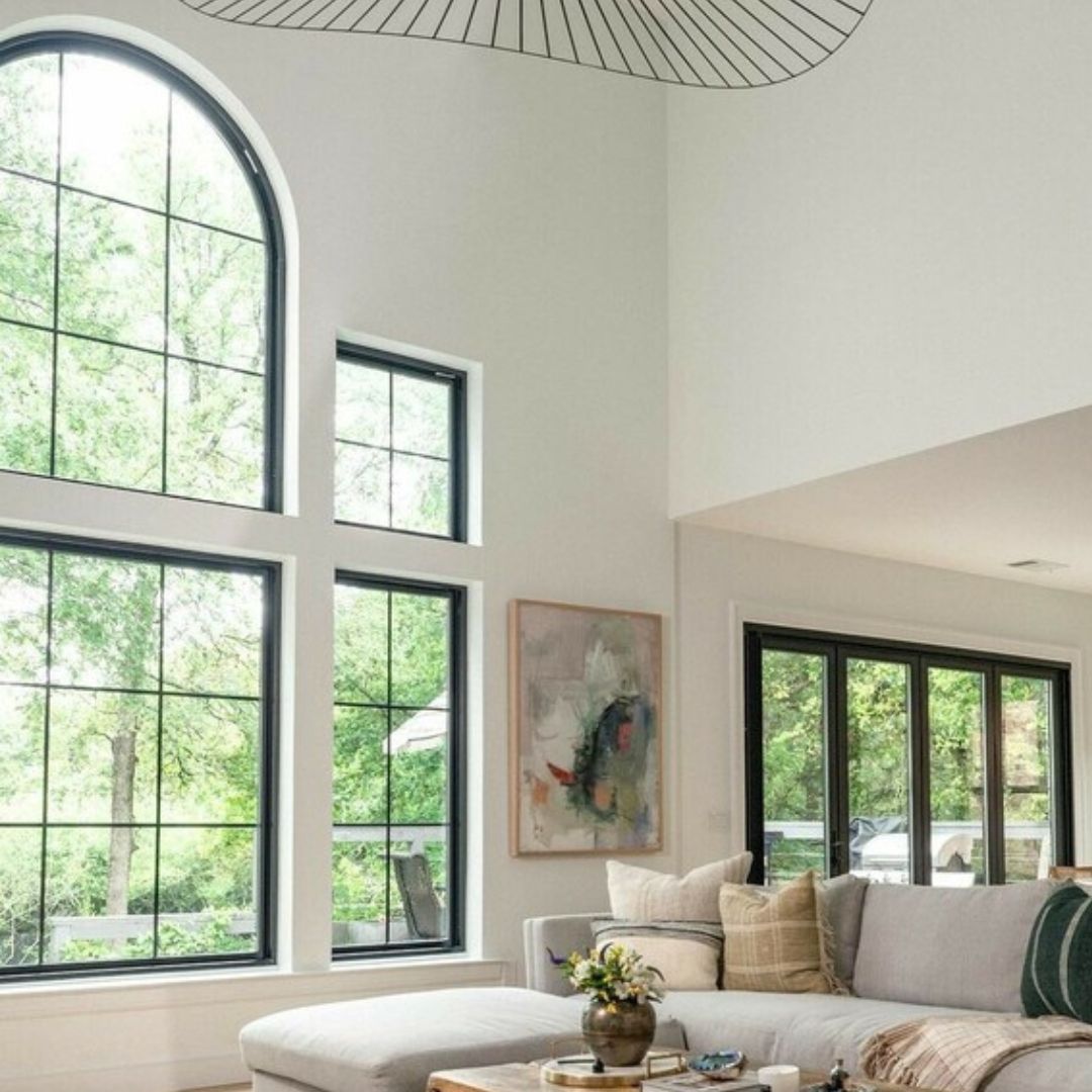 Bright, airy living room with large windows and modern decor.