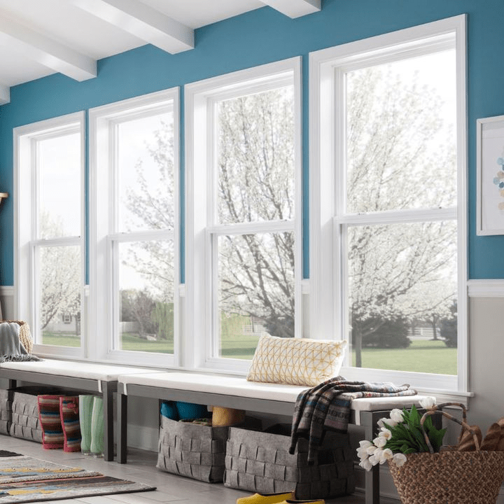 Bright room with large white windows and blue walls