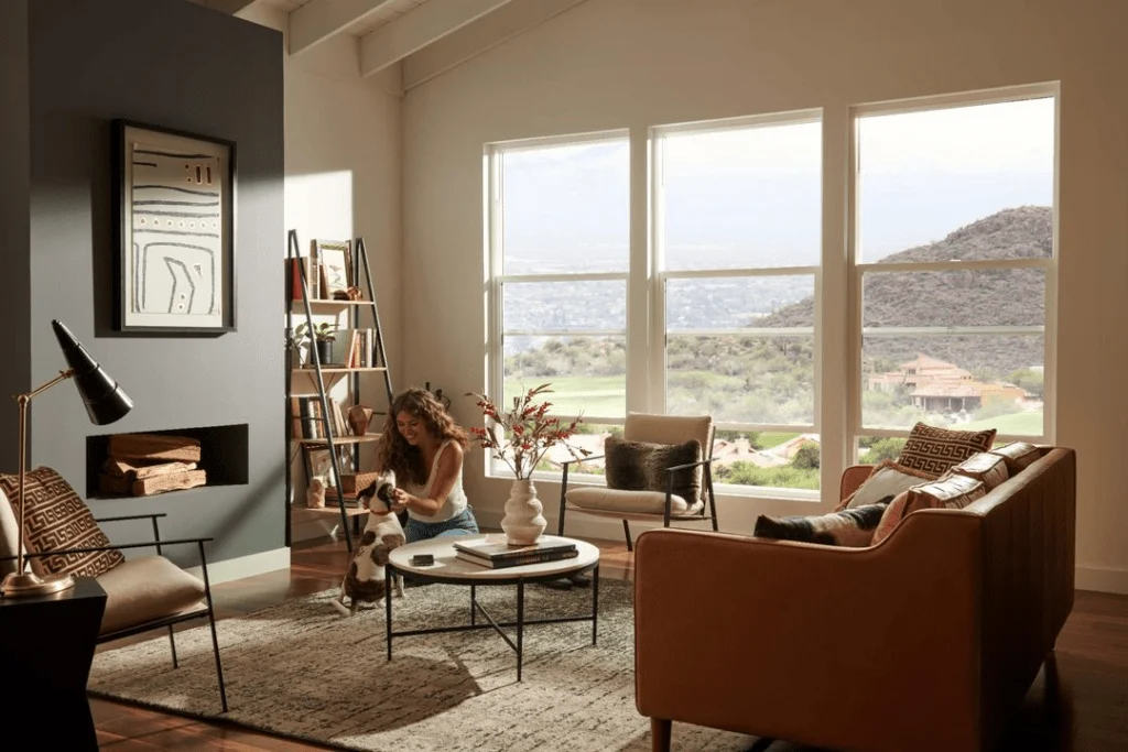 Woman playing with dog in a stylish living room