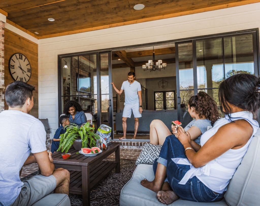 Friends enjoying snacks on cozy porch with open doors