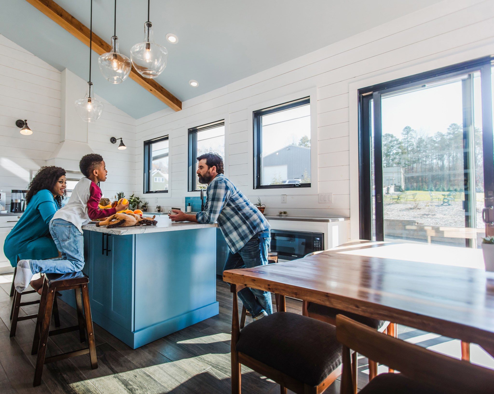 Family enjoying time in bright modern kitchen